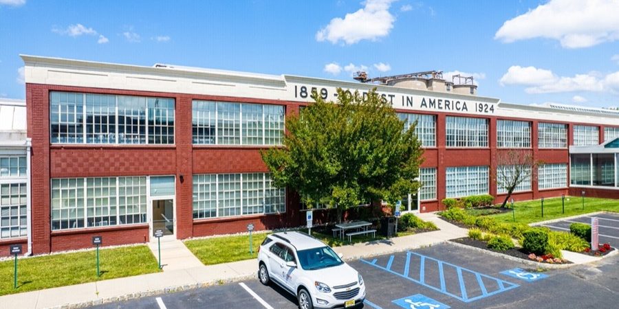 an office building with a car parked in front