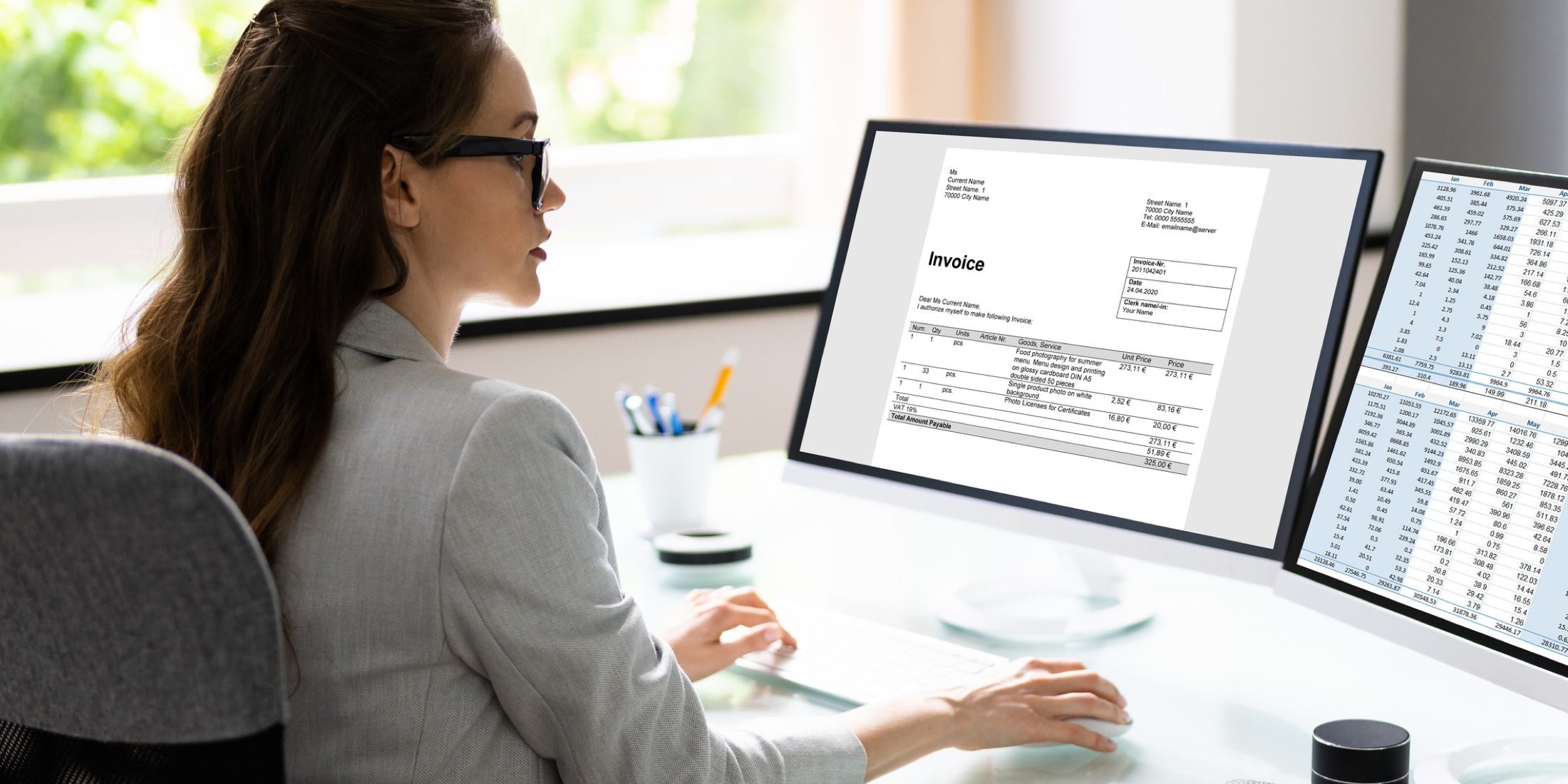 A woman in an office desk, analyzing financial data