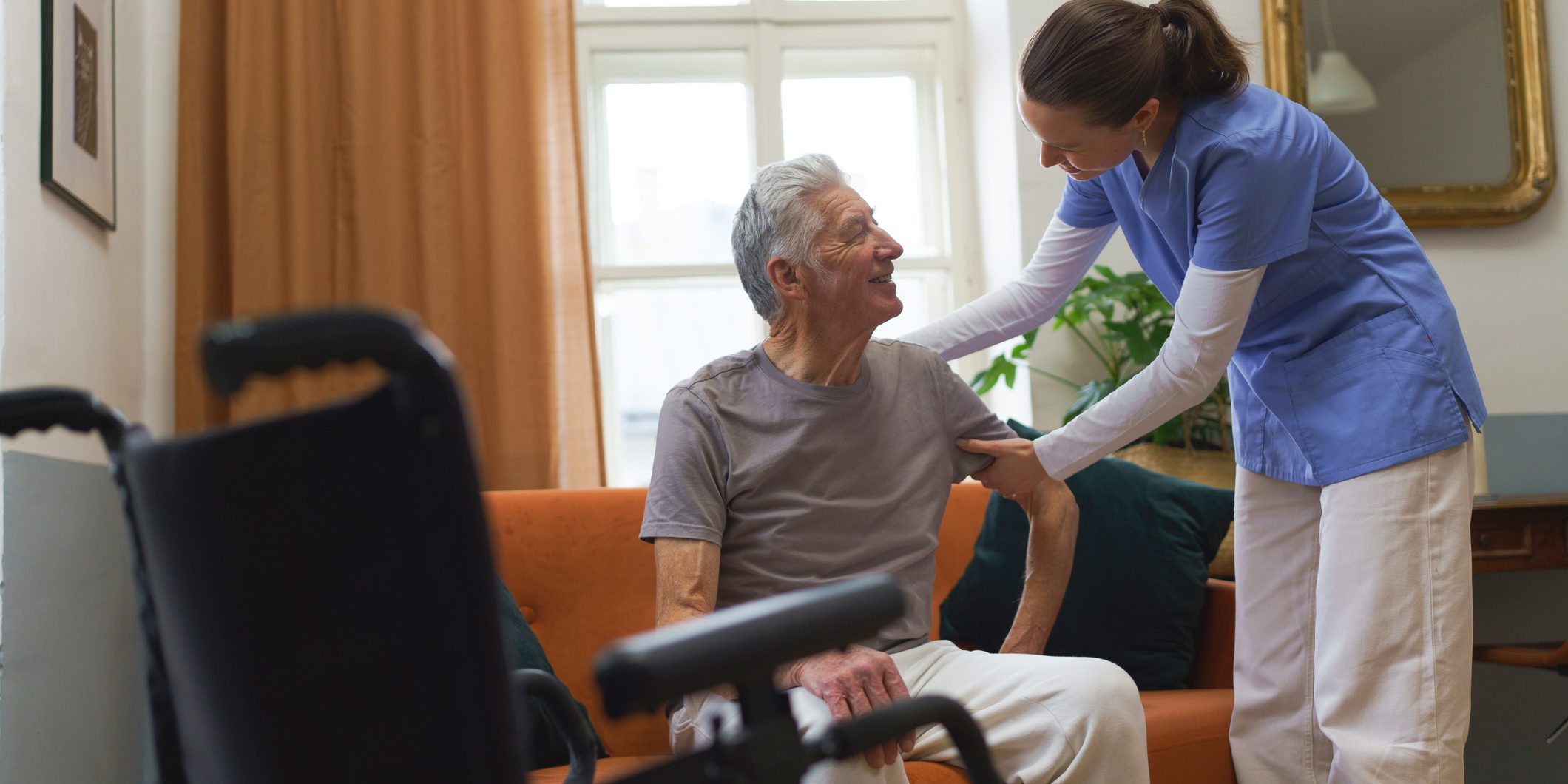 Old man being helped by nurse