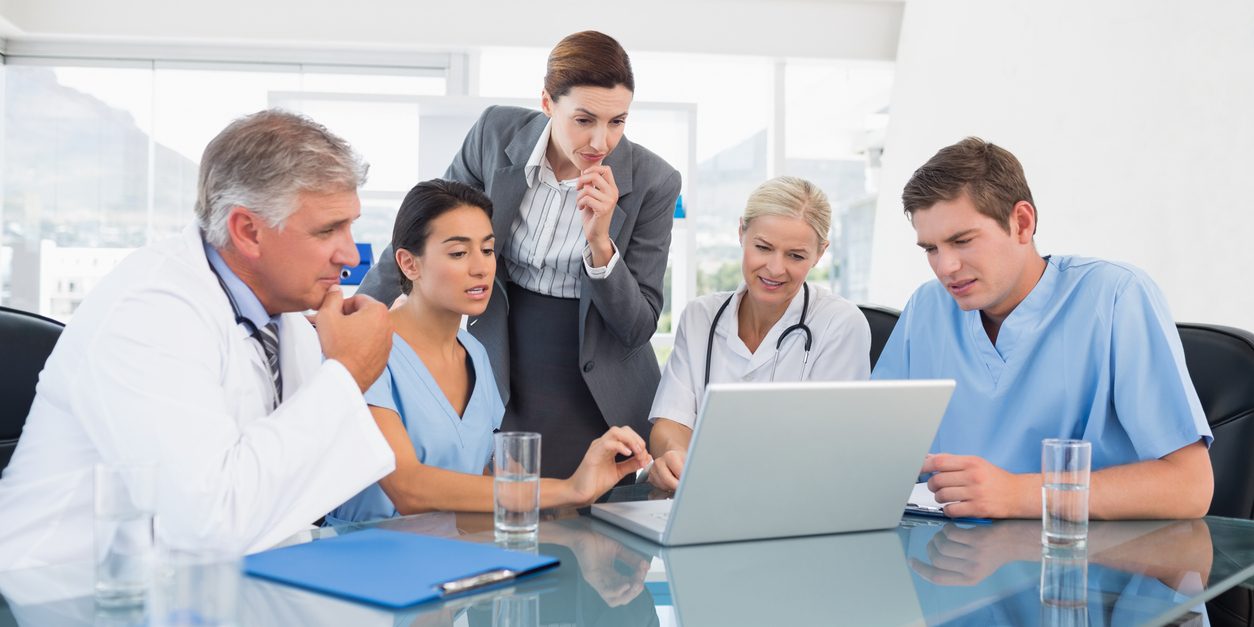 Team of doctors and businesswoman having a meeting in medical office