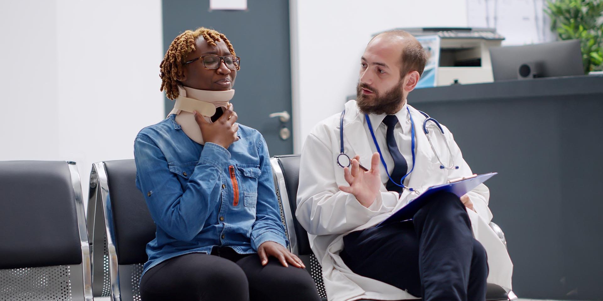 Doctor talking to patient with neck brace