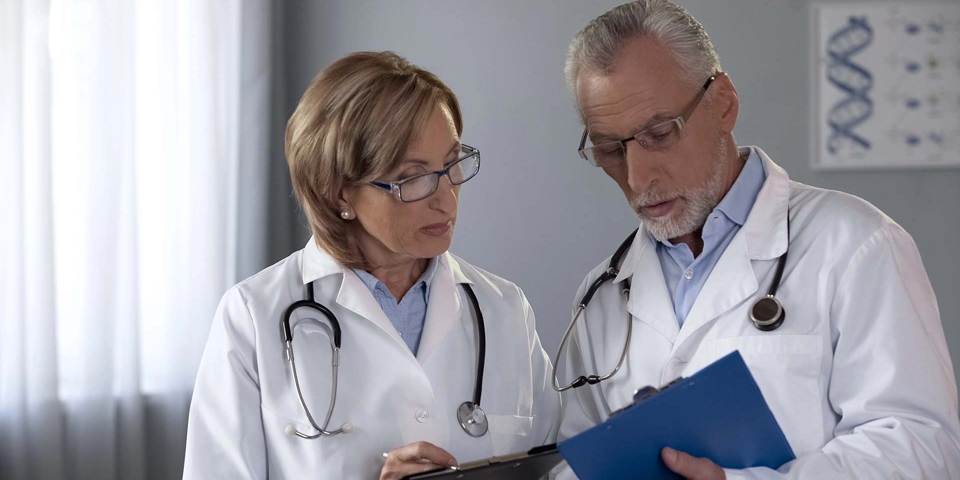 Male doctor conferring with female doctor